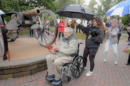 Dick Desckovick cuts the ribbon to the restored Revolutionary War replica cannon. 