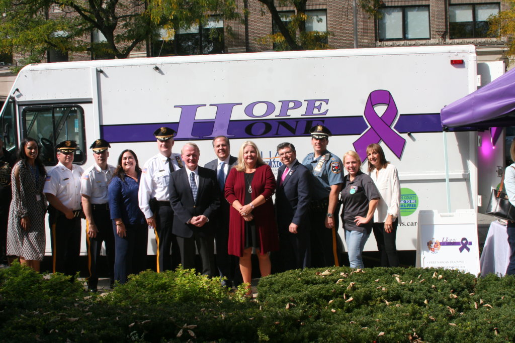 Sheriff Gannon, Congressman Lance, and other dignitaries stand in front of the Hope One van