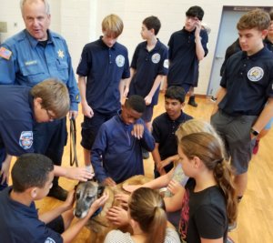 Members of the Hanover Youth Public Safety Academy lavish attention on Cinders, a Morris County Sheriff's Office canine trained to detect accelerants at suspected arson scenes. K-9 Cinders' handler, Sheriff's Office Detective John Granato, stands at left. 