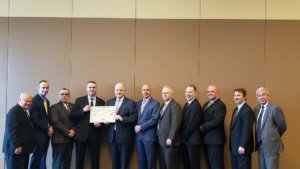 Morris County Jail Warden Christopher Klein and Morris County Sheriff James Gannon, holding accreditation certificate, surrounded by jail superior officers and officials of the American Correctional Association in Louisiana. 