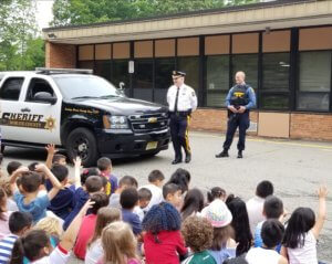 Morris County Sheriff James M. Gannon and K-9 Section Detective Marc Adamsky chat with pupils at the Normandy Park School in Morris Township on Cool To Be Kind Community Day held on May 29, 2019