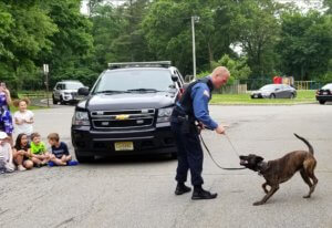 Morris County Sheriff's Office K-9 Section Detective Marc Adamsky shows Normandy Park School pupils the talents of his K-9 partner, Tim, during Cool To Be Kind Community Day. 