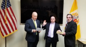 New Morris County Sheriff's Office Bureau of Corrections Officer Michael Garramone is sworn in on February 7, 2020, by Morris County Sheriff James M. Gannon while his father holds the Bible.