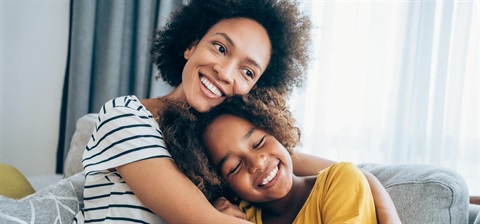 Black mother and daughter hugging