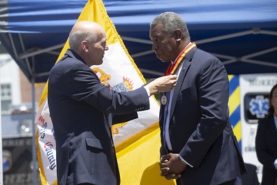 Commissioner Krickus gives a medal to Veteran Stanislaus