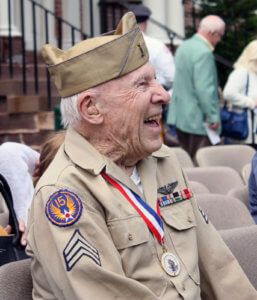 Hjalmar Johansson, WW2 vet and keynote speaker, smiling as he watches the ceremony