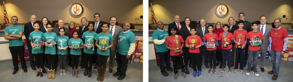 Freeholders pose with two robotics teams.