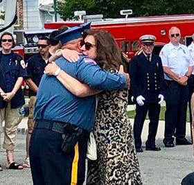 Chief Fernandez gets a hug at his walking out'' ceremony, June 28