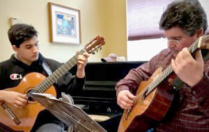 Alex and Darren O'Neill play guitar.