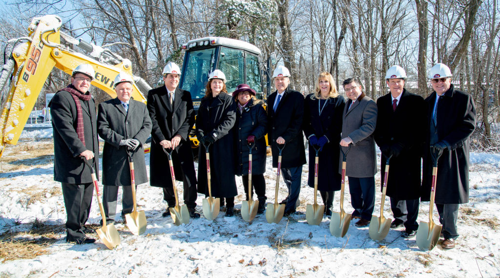 Officials pose with golden shovels at the groundbreaking ceremony.