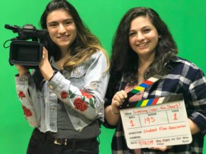 Film club students in front of a green screen