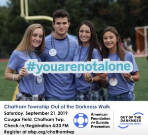 Students hold a sign that reads #youarenotalone