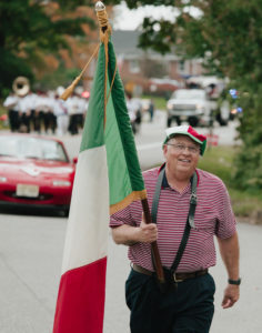 Man carries the Italian flag in the parade