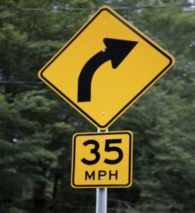 road sign showing curve and 35MPH