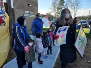 Freeholders Smith and Selen display artwork shared by Head Start children