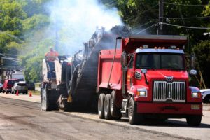 Heavy Duty Trucks Paving a Road