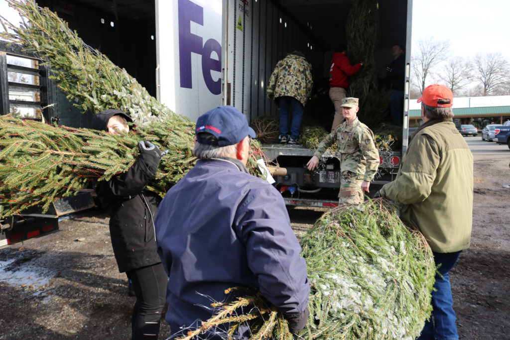 In 2019, volunteers load trees into a truck.